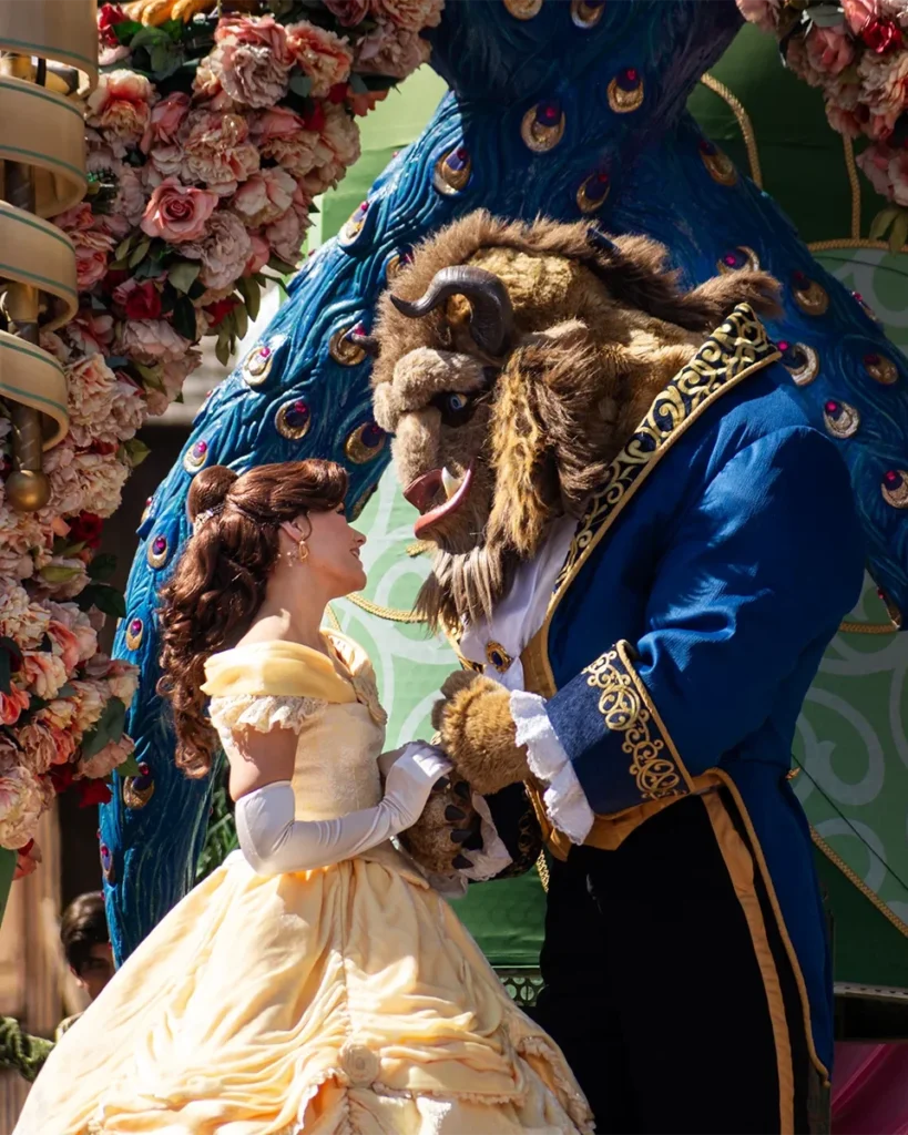 Belle and the Beast appearing together during a colourful community parade event.